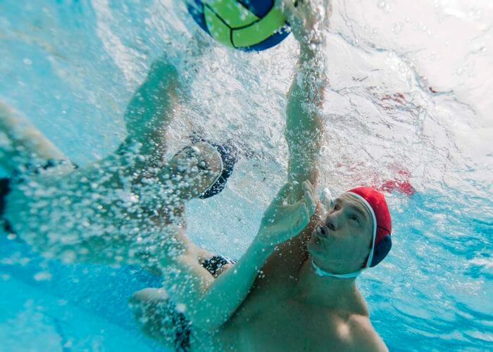 Two young men playing water polo